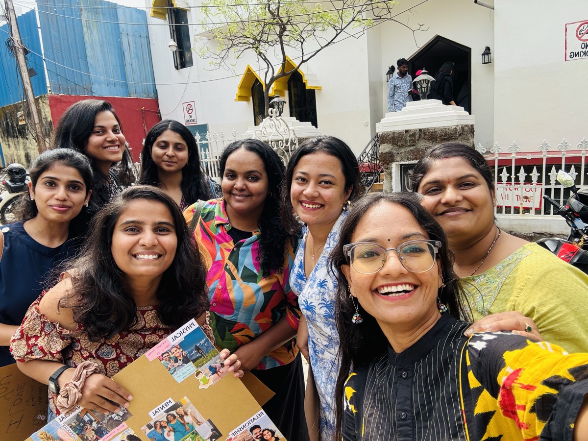Women on a day out, holding a vision board